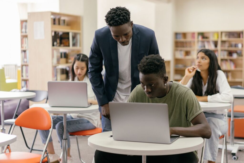 Teacher guiding a student working with an AI study tool
